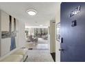 Inviting condo entryway with neutral decor leads to a bright living space, offering a glimpse of the beautiful view at 6415 Midnight Pass Rd # 211, Sarasota, FL 34242