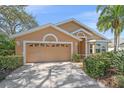 Well-maintained home with a spacious driveway and a two-car garage featuring decorative window accents at 7312 Eleanor Cir, Sarasota, FL 34243