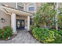 Charming front entrance with a beautiful double-door, decorative plants, and a tiled walkway at 820 Placid Lake Dr, Osprey, FL 34229