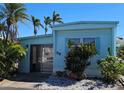 Charming single-story home featuring blue siding, well-maintained landscaping, and a welcoming front entrance at 10315 Cortez W Rd # 28-1, Bradenton, FL 34210