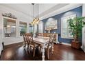 Elegant dining room with hardwood floors, stylish lighting, and bright windows at 10406 Eastwood Dr, Bradenton, FL 34211