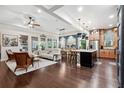 A spacious and well-lit living room with hardwood floors, an open layout and a modern kitchen at 10406 Eastwood Dr, Bradenton, FL 34211