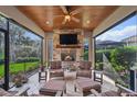 Inviting covered patio with a stone fireplace, ceiling fan, and comfortable seating at 10406 Eastwood Dr, Bradenton, FL 34211