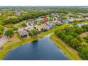 Aerial view shows the lake, trees and houses in this residential neighborhood at 12211 Lavender Loop, Bradenton, FL 34212