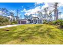 Beautiful view of single Gathering home on a bright sunny day with green yard at 12495 Patsy Ave, Port Charlotte, FL 33981