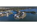 Stunning aerial view of waterfront property showcasing home's private island location and expansive views at 1300 Tangier Way, Sarasota, FL 34239