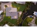 Aerial view of waterfront home with a metal roof, private boat dock, and an outdoor patio space at 1528 43Rd Avenue W Dr, Palmetto, FL 34221