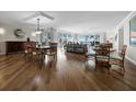 Expansive dining room with hardwood flooring, water views, and elegant furnishings at 2410 Harbourside Dr # 121, Longboat Key, FL 34228