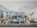 Cozy living room boasts water views, comfortable seating, and an abundance of natural light at 2410 Harbourside Dr # 121, Longboat Key, FL 34228