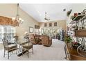 Bright living room featuring high ceilings, elegant chandelier, comfortable seating, and a serene view of the outdoors at 306 Lynbrook Cir # 201, Venice, FL 34292