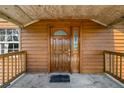 A wooden front door with glass panel and a 