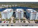 Drone shot of bayfront condominiums with dedicated parking and easy access to nearby waterways and beaches at 383 Aruba Cir # 102, Bradenton, FL 34209