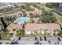 Aerial view showcasing the community pool area surrounded by residential condos and lush landscaping at 4008 Crockers Lake Blvd # 13, Sarasota, FL 34238