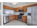 Efficient kitchen with stainless steel appliances, oak cabinetry, and practical design elements at 4658 Sabal Key Dr, Bradenton, FL 34203