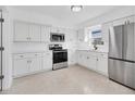 Bright kitchen with stainless steel appliances, white cabinetry, and modern finishes at 4822 Linwood St, Sarasota, FL 34232