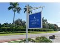 A welcoming Harbor Hills community sign against a backdrop of lush tropical landscaping and clear blue sky at 503 Park Dr, Bradenton, FL 34209
