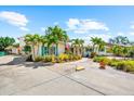 Charming home with lush landscaping, palm trees, turquoise shutters, and a spacious driveway at 503 Park Dr, Bradenton, FL 34209