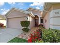Welcoming home exterior with mature landscaped garden, walkway to front door, and attached two-car garage at 5141 Lansdowne Way, Palmetto, FL 34221