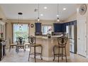 Bright kitchen with stainless steel appliances, granite countertops, navy blue cabinets, and eat in breakfast nook at 5141 Lansdowne Way, Palmetto, FL 34221