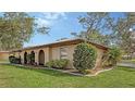Beautiful one-story home featuring a low-pitched tile roof, stucco walls, arched doorway, and lush landscaping at 515 Rousseau Dr, Nokomis, FL 34275