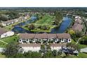 Aerial view of condo community nestled near a scenic golf course and tranquil lake views at 5310 Hyland Hills Ave # 2114, Sarasota, FL 34241