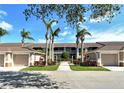 Well-maintained condo building with mature landscaping, sidewalks, and attached garages at 5320 Hyland Hills Ave # 2222, Sarasota, FL 34241