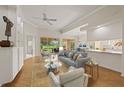 Bright living room with vaulted ceilings, neutral walls, and views of the screened lanai and garden at 5539 Octonia Pl, Sarasota, FL 34238