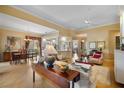 Spacious living room that connects the kitchen and dining area with open floor plan and wood floors at 5539 Octonia Pl, Sarasota, FL 34238