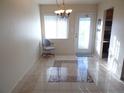 Bright dining area features tile flooring, a modern chandelier, and a glass door that offers plenty of natural light at 5889 Garden Ln # H4, Bradenton, FL 34207