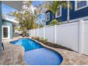Private pool area with a paver patio, surrounded by tropical landscaping at 6201 Holmes Blvd, Holmes Beach, FL 34217