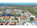 Expansive aerial shot of a residential area featuring homes, roads, ponds and green spaces at 6911 Stetson Street Cir, Sarasota, FL 34243