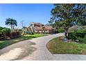 Charming home with a paver driveway, lush landscaping, and a well-manicured lawn at 6919 Winners Cir, Lakewood Ranch, FL 34202