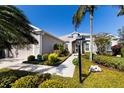 The inviting facade of this home is highlighted by a lush garden and a concrete pathway leading to the front door at 8803 18Th Nw Ave, Bradenton, FL 34209