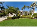 Well-manicured lawn and mature palm trees accentuate the facade of this appealing single story home at 8803 18Th Nw Ave, Bradenton, FL 34209