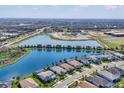 Scenic aerial view of a community near a large lake with beautiful homes and mature trees at 12326 Blue Hill Trl, Bradenton, FL 34211