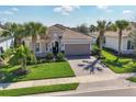 Charming single-Gathering home boasts a well-kept lawn, brick driveway, and decorative palm trees at 12326 Blue Hill Trl, Bradenton, FL 34211