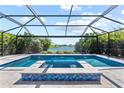 Beautiful pool with water features and a view of the adjacent pond at 12716 Dusty Trail Dr, Sarasota, FL 34238