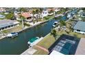 Waterfront property featuring a screened-in pool, boat dock, and canal access in a serene community at 1541 Shelburne Ln, Sarasota, FL 34231