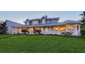 An attractive home boasts a generous front lawn, graceful columns, and a welcoming facade at 1543 Eastbrook Dr, Sarasota, FL 34231