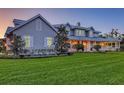 A picturesque home exhibits a sprawling lawn, inviting front porch, and timeless architectural design at 1543 Eastbrook Dr, Sarasota, FL 34231