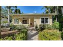 Inviting front porch with a cozy swing and well-maintained landscaping surrounding the entrance at 1631 Loma Linda St, Sarasota, FL 34239