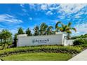 Avelina Wellen Park community entrance sign surrounded by beautiful landscaping against a blue sky at 18771 Toulon Ct, Venice, FL 34293