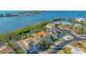 An aerial view shows the luxurious property situated near the water with tropical landscaping surrounding the home at 3491 Bayou Sound, Longboat Key, FL 34228