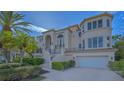 This two-story home has a front-facing two-car garage, staircase entrance, and well-maintained landscaping at 3491 Bayou Sound, Longboat Key, FL 34228