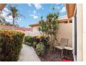 Outdoor courtyard area features lush landscaping and a seating area for relaxing at 4240 Marseilles Ave # 3248, Sarasota, FL 34233