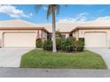 Welcoming single story home with a well-maintained lawn and colorful flowerbeds in front at 4240 Marseilles Ave # 3248, Sarasota, FL 34233
