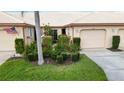 Charming single-story home featuring a beautiful landscaped front yard, neutral color palette and an attached garage at 4240 Marseilles Ave # 3248, Sarasota, FL 34233