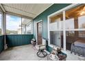 View of screened lanai with seating, decor, ceiling, window, and door at 4802 51 W St # 1017, Bradenton, FL 34210