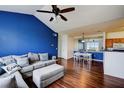 Living room with hardwood floors, sofa, ottoman, and access to the dining area at 4802 51 W St # 1017, Bradenton, FL 34210
