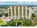 Upscale condo building exterior showcases multiple balconies, a pool, a water fountain, and manicured greenery at 501 Haben Blvd # 204, Palmetto, FL 34221